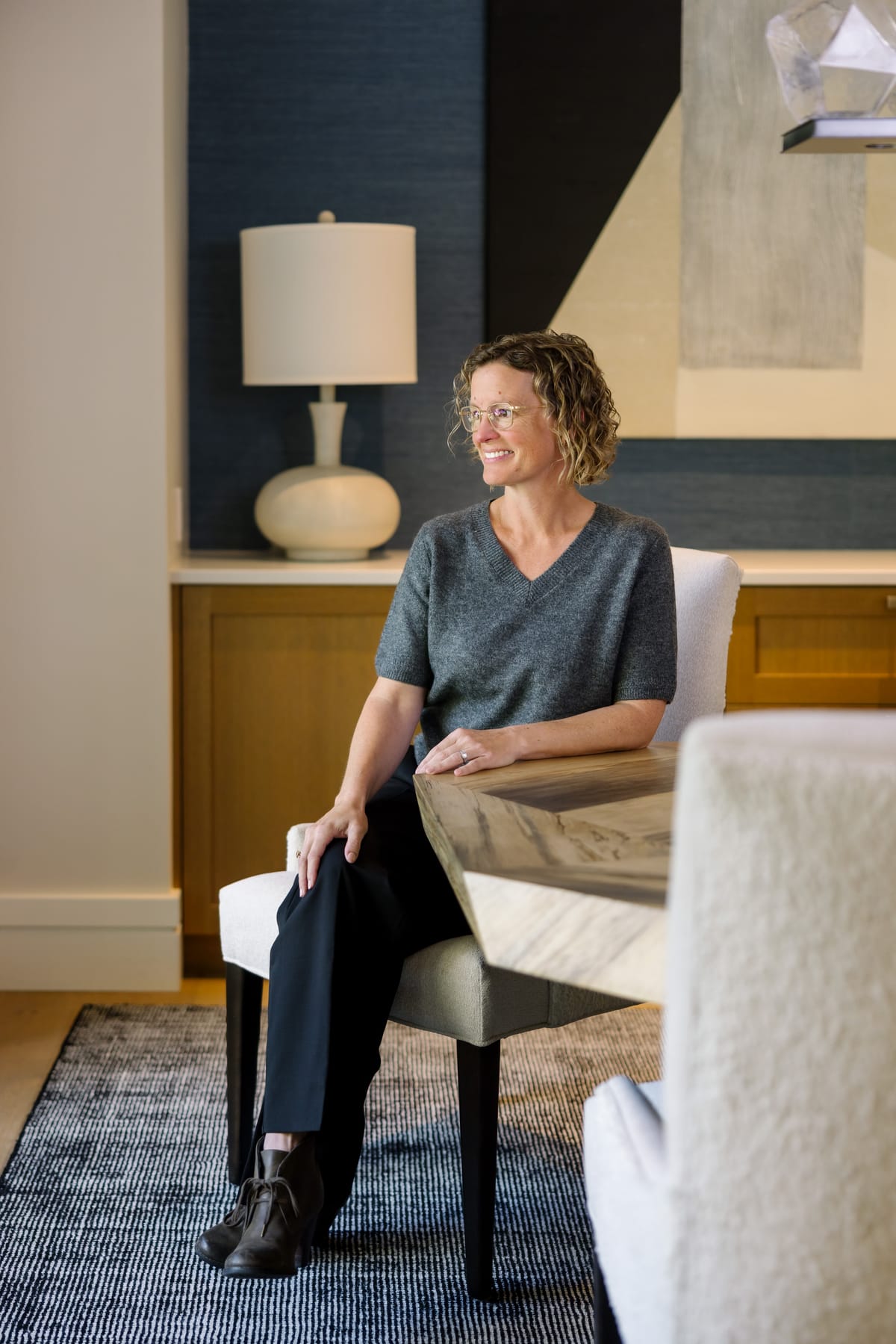 Molly Stauffer seated at a dining table, smiling