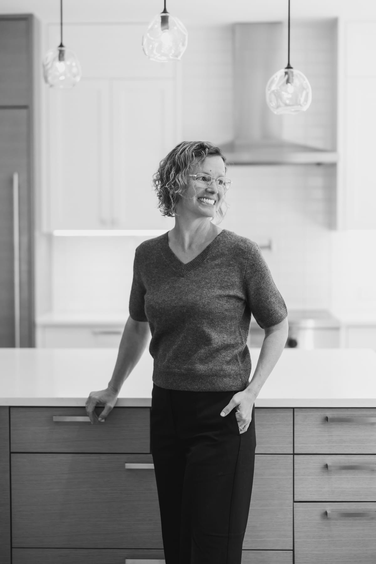 Molly Stauffer leaning on a kitchen island, smiling